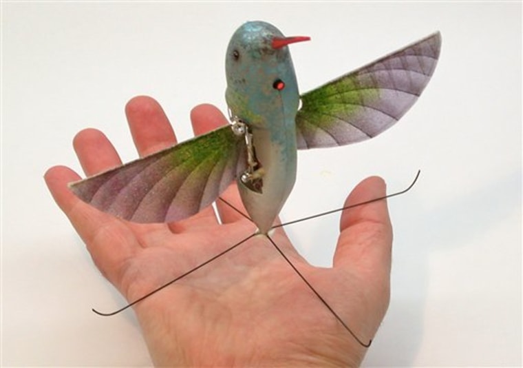 This image provided by AeroVironment Inc., shows a life-size Hummingbird-like unmanned aircraft, named Nano Hummingbird, developed by AeroVironment Inc., for the Defense Advanced Research Projects Agency (DARPA). The prototype has a wingspan of 6.5 inches, weighs two-thirds of an ounce and has a body fairing shaped like a real hummingbird.(AP Photo/AeroVironment Inc.) NO SALES